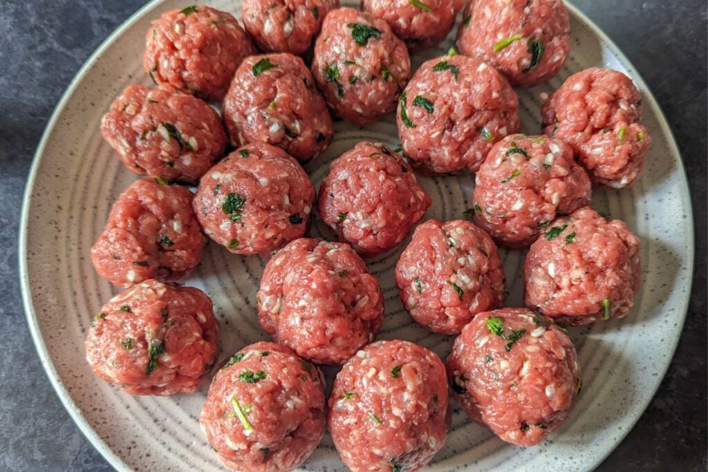 Raw Meatballs for Romanian soup on grey plate