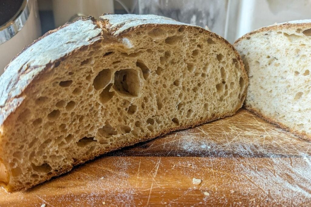 Cut sourdough showing nice and open crumb with typical sourdough holes