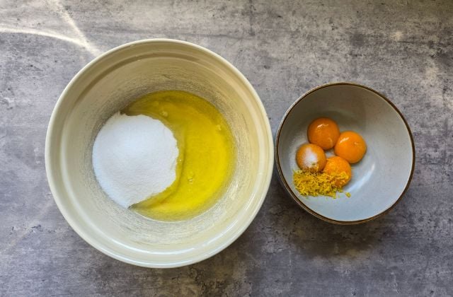 Separated eggs and sugar prepared in bowls for making Pan di Spagna sponge cake batter.