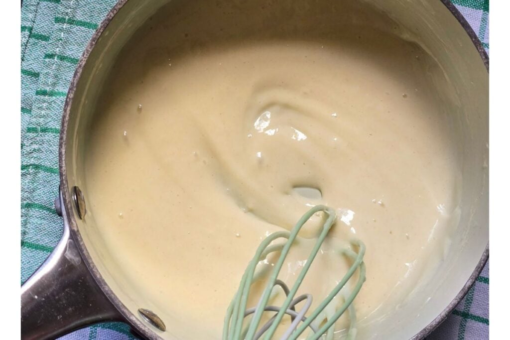 Thick, glossy tangzhong paste in a saucepan, whisked smooth and ready to cool before it goes into the dough.